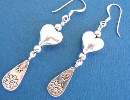  fish hook sterling silver puff heart earring holding a water-drop