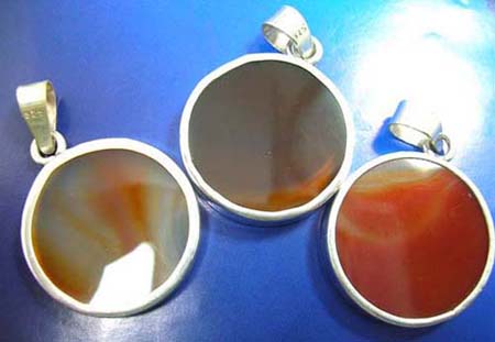  sterling silver pendant with rounded orange agate stone inlaid